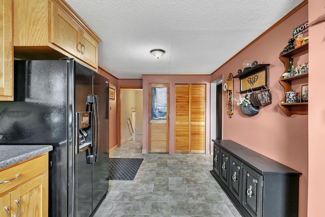 kitchen with open shelves, light brown cabinetry, a textured ceiling, and black fridge