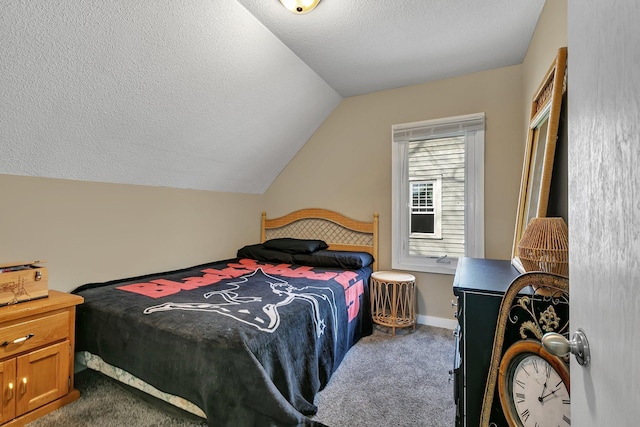 bedroom with lofted ceiling, dark colored carpet, and a textured ceiling
