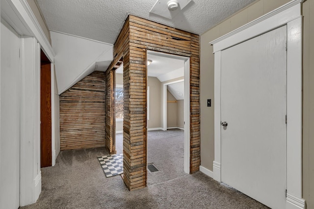 interior space with visible vents, carpet floors, and a textured ceiling