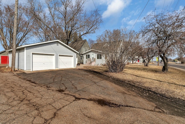 single story home featuring an outbuilding and a garage