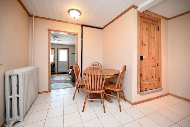 dining room with baseboards, a ceiling fan, radiator heating unit, and crown molding