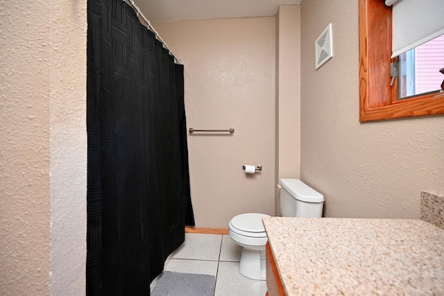 full bath with vanity, a shower with shower curtain, visible vents, tile patterned floors, and toilet