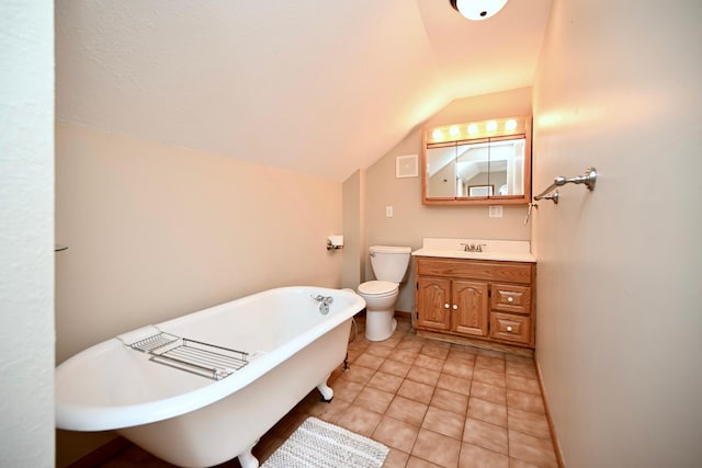 bathroom featuring vanity, baseboards, a soaking tub, lofted ceiling, and toilet