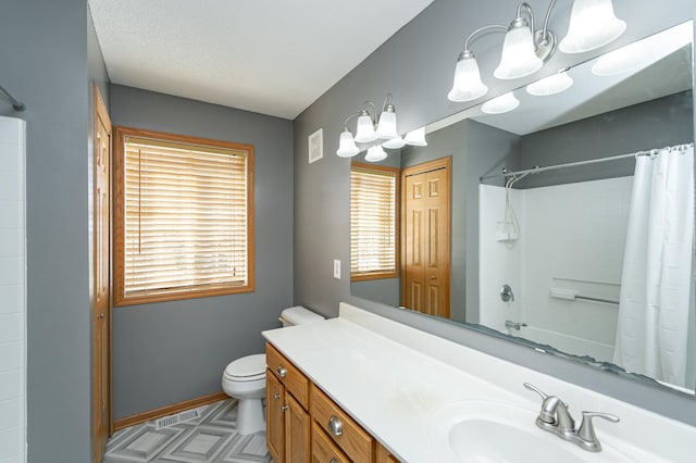 bathroom with baseboards, a notable chandelier, vanity, and toilet