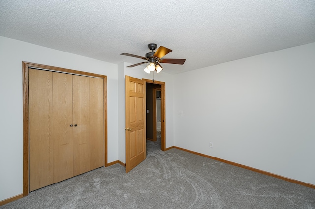 unfurnished bedroom with a ceiling fan, carpet, baseboards, a closet, and a textured ceiling