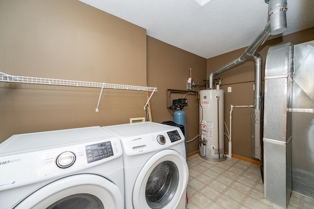 laundry room with light floors, laundry area, a textured ceiling, gas water heater, and washing machine and dryer