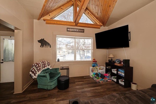 sitting room featuring baseboards, wood finished floors, and vaulted ceiling with beams