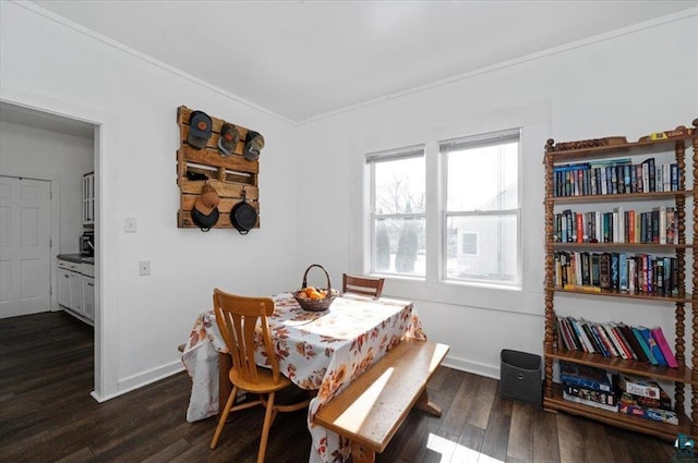 dining space featuring ornamental molding, baseboards, and dark wood-style flooring