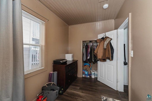 bedroom featuring dark wood-type flooring, wood ceiling, and ornamental molding