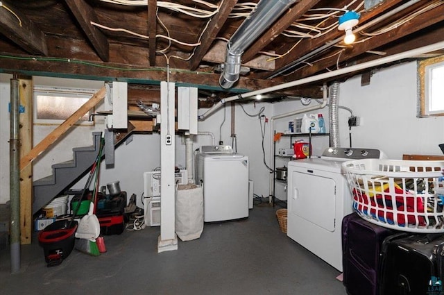 below grade area with stairs and washer and clothes dryer