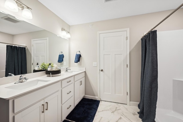 bathroom featuring visible vents, baseboards, double vanity, marble finish floor, and a sink