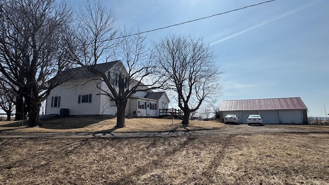 view of home's exterior featuring central air condition unit and an outbuilding