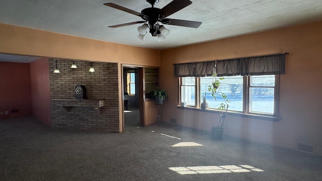 unfurnished living room featuring ceiling fan and a textured ceiling