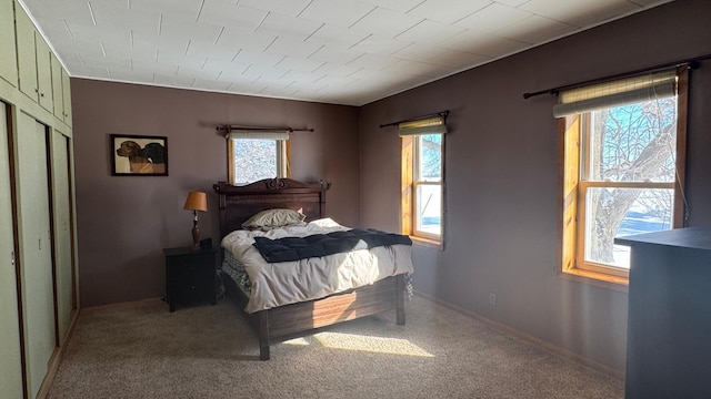 carpeted bedroom featuring baseboards