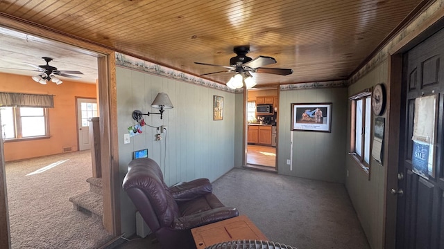 interior space featuring wood ceiling, light colored carpet, and visible vents