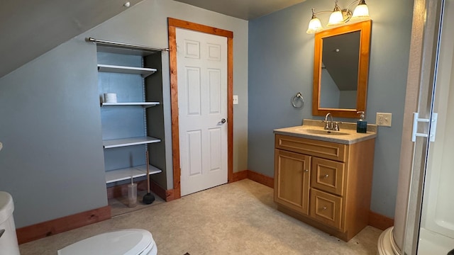 bathroom featuring vanity, toilet, and baseboards