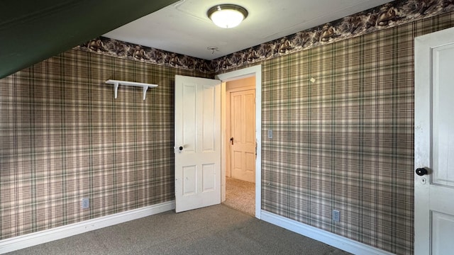 bathroom featuring wallpapered walls and baseboards