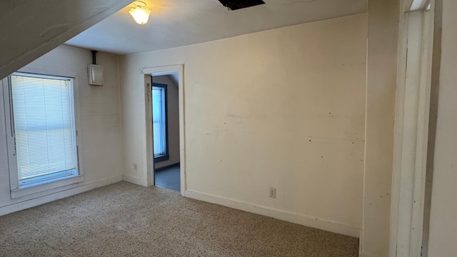 carpeted empty room with baseboards