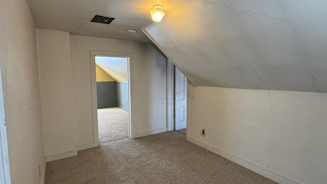 bonus room with lofted ceiling, carpet flooring, and baseboards