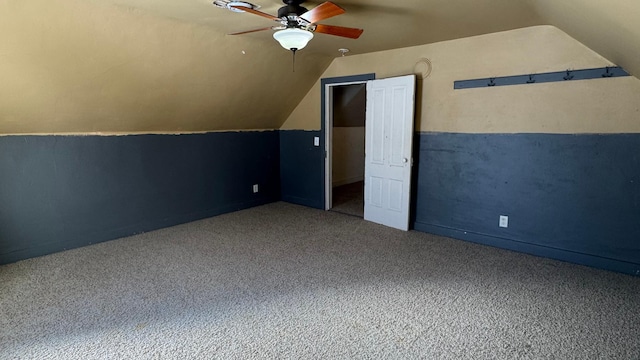 additional living space with carpet flooring, ceiling fan, and vaulted ceiling