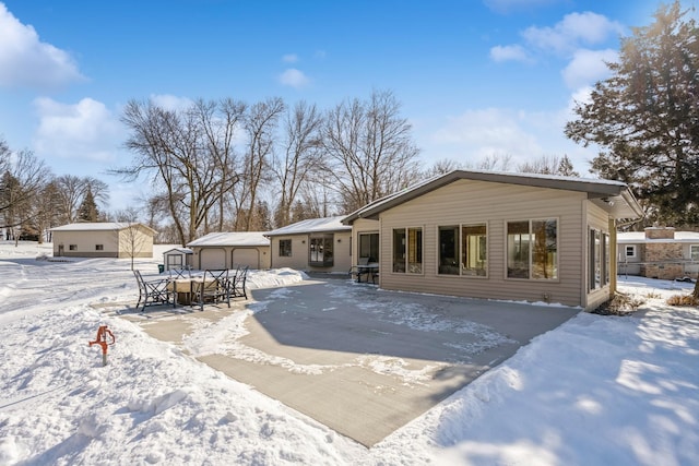 view of snow covered back of property