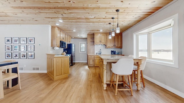 kitchen featuring a wealth of natural light, visible vents, light wood-style flooring, and light countertops