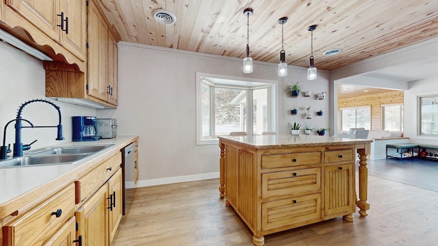 kitchen featuring a sink, visible vents, light wood-style floors, and light countertops