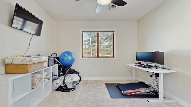 exercise area featuring visible vents, baseboards, a ceiling fan, and carpet flooring