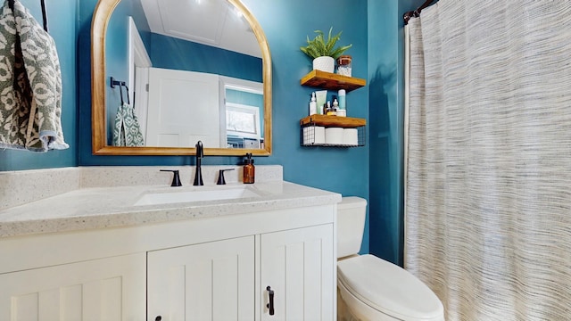 bathroom featuring a shower with shower curtain, toilet, and vanity