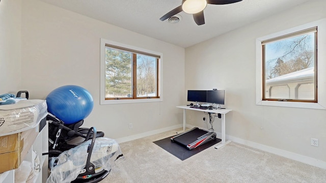 exercise room with carpet flooring, visible vents, baseboards, and ceiling fan