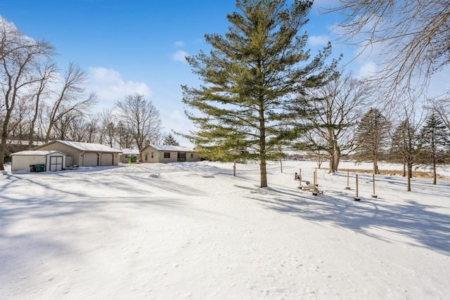 snowy yard with a garage