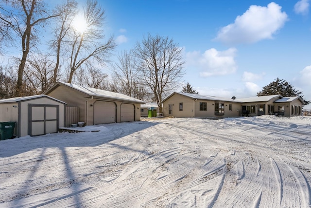 view of front of property featuring an outbuilding, a storage unit, and a garage