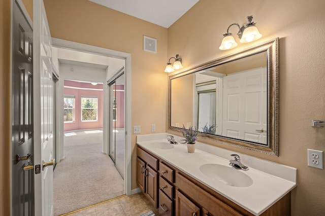 full bathroom featuring a sink, tile patterned floors, double vanity, and visible vents