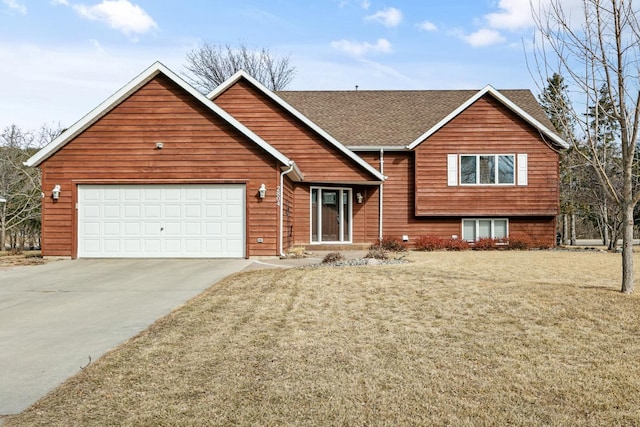 view of front facade with an attached garage, concrete driveway, a front lawn, and roof with shingles