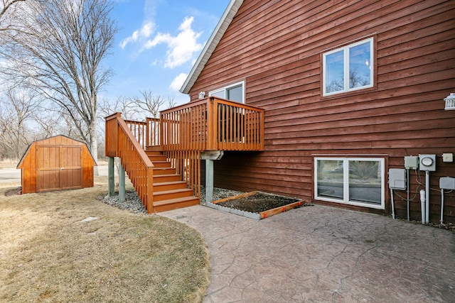 exterior space with a shed, stairway, a wooden deck, an outbuilding, and a patio