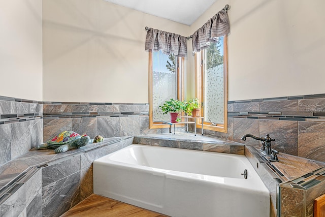 bathroom featuring a bath and wood finished floors