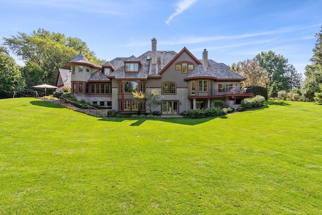 781 Ferndale Rd N, Orono, MN 55391 - back of property with a balcony, a chimney, and a lawn