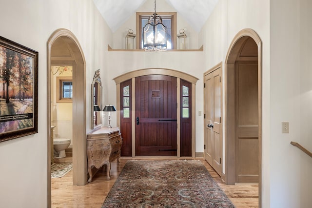 781 Ferndale Rd N, Orono, MN 55391 - foyer entrance with a wealth of natural light, light wood-type flooring, a chandelier, and arched walkways