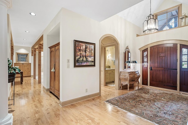 781 Ferndale Rd N, Orono, MN 55391 - foyer with a notable chandelier, recessed lighting, baseboards, arched walkways, and light wood-type flooring