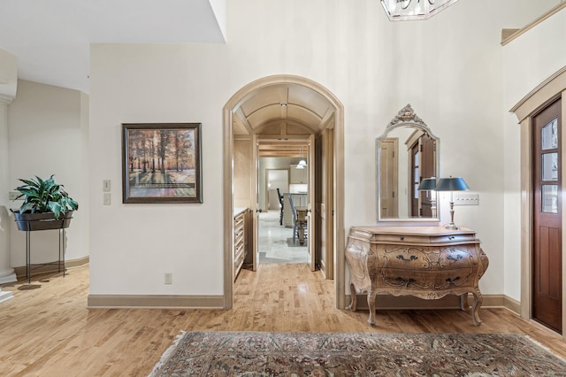 781 Ferndale Rd N, Orono, MN 55391 - hall featuring arched walkways, baseboards, and light wood-style flooring