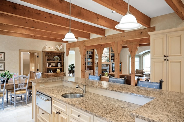 781 Ferndale Rd N, Orono, MN 55391 - kitchen with hanging light fixtures, a sink, beam ceiling, a warming drawer, and light stone counters