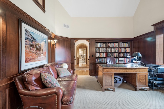 781 Ferndale Rd N, Orono, MN 55391 - office with visible vents, a towering ceiling, arched walkways, and light carpet