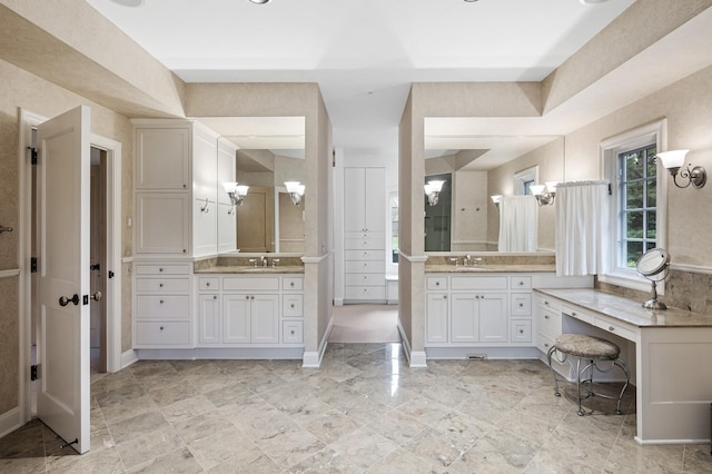 781 Ferndale Rd N, Orono, MN 55391 - bathroom featuring a shower, baseboards, two vanities, and a sink