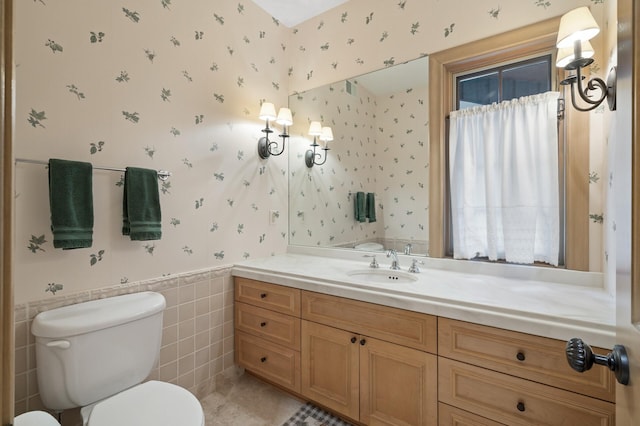 781 Ferndale Rd N, Orono, MN 55391 - bathroom with toilet, wallpapered walls, tile walls, wainscoting, and vanity