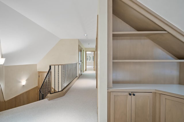 781 Ferndale Rd N, Orono, MN 55391 - hallway with lofted ceiling, carpet flooring, an upstairs landing, and wooden walls