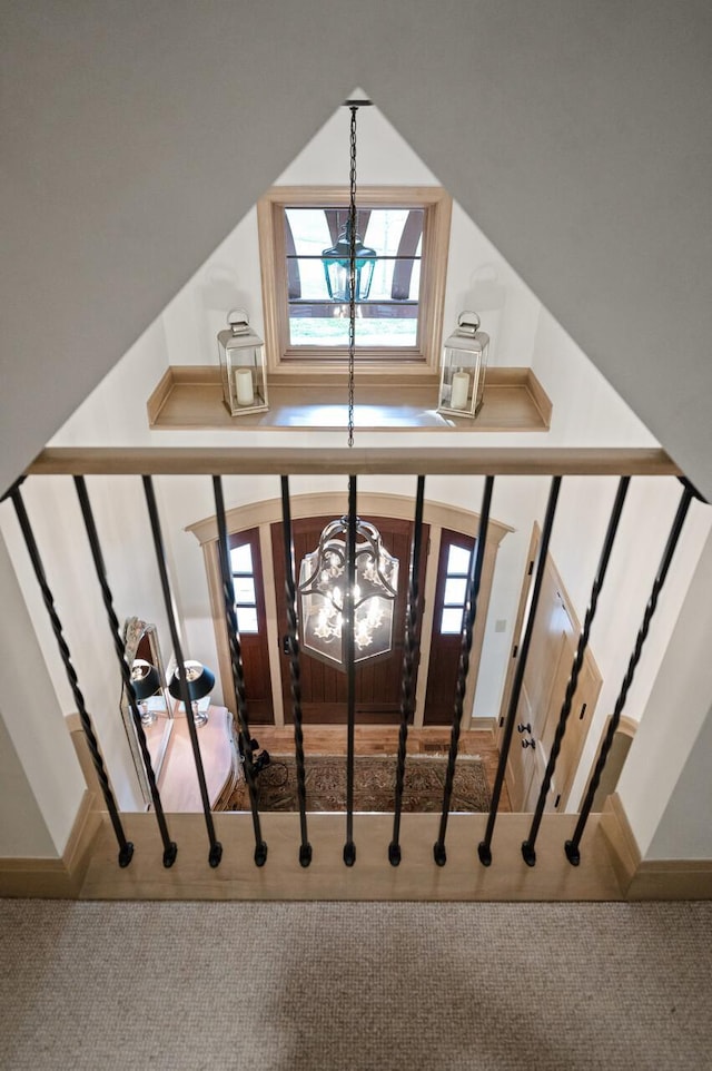781 Ferndale Rd N, Orono, MN 55391 - stairway with a wealth of natural light, baseboards, carpet floors, and a notable chandelier