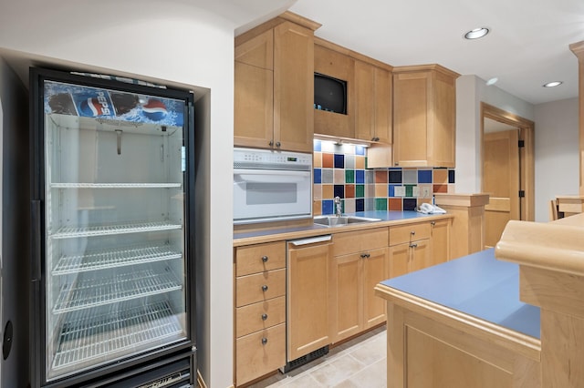 781 Ferndale Rd N, Orono, MN 55391 - kitchen featuring light brown cabinetry, decorative backsplash, a sink, and white oven