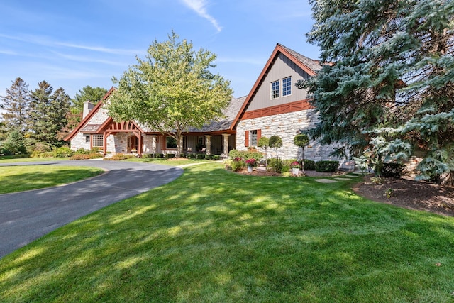781 Ferndale Rd N, Orono, MN 55391 - tudor home with a chimney, a front lawn, and stone siding