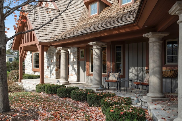 781 Ferndale Rd N, Orono, MN 55391 - view of exterior entry with stone siding, a porch, and board and batten siding