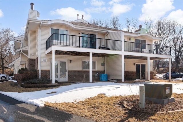 view of front of property with brick siding and a chimney